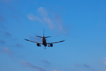 Commercial aircraft overflying the sky and arriving at airport