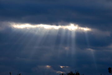 sky between open with rays of sunlight coming through the clouds