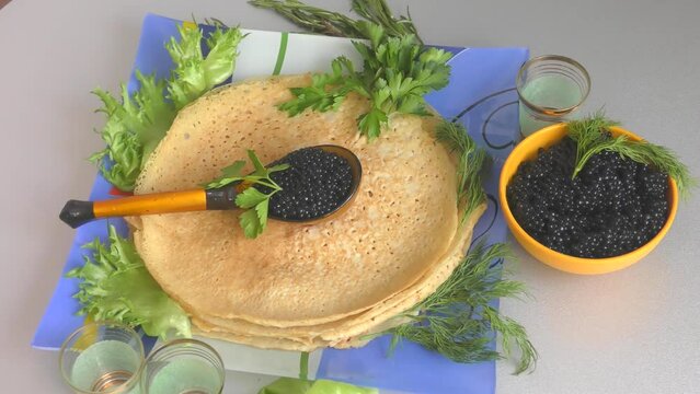 Pancakes with black caviar, cooked for Maslenitsa. Maslenitsa is an East Slavic traditional holiday celebrated during the week before Lent.