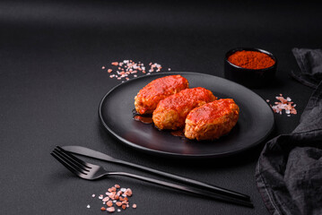 Meat cutlet or meatballs in tomato sauce with garlic, salt, spices and herbs