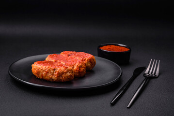 Meat cutlet or meatballs in tomato sauce with garlic, salt, spices and herbs
