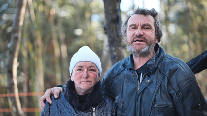 Homeless people are interviewed in the winter in the woods. - obrazy, fototapety, plakaty