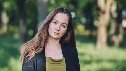 Portrait of a young student in a city park.