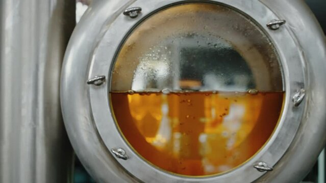 modern brewery, wort is brewing in tank, closeup view, producing of craft beers