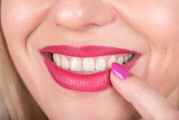 Naklejka premium Happy Smile Woman Face with Open Mouth and Red Lipstick and Polish Nail on Lip. Curious. Studio Photo Shoot.