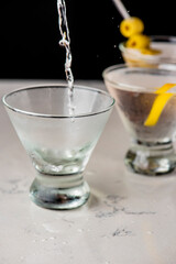 Martini cocktail. Classic cocktail made with gin or vodka and vermouth, and garnished with an olive or a lemon twist. The best-known mixed alcoholic beverage.