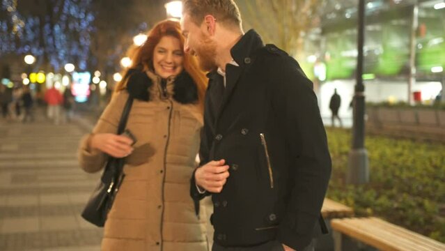 Winter holidays - happy young couple on Christmas evening, marriage proposal