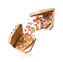 Two freshly baked pizzas with ingredients in the air on a white background