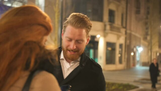 Winter holidays - happy young couple on Christmas evening, marriage proposal
