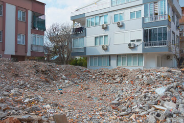 Destroyed homes ruins pile of concrete and bricks in after the earthquake. Demolished buildings,...