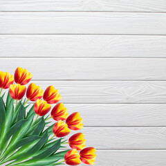 Bouquet of tulips on a white wooden background with copyspace for a message. Floral frame. Bouquet of  flowers. Flat lay.
