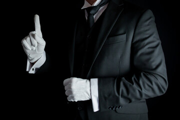 Portrait of Butler in Dark Suit and White Gloves With Hand Raised Politely. Concept of Service...