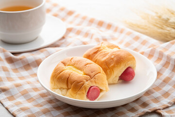Buns stuffed with sausage and Cheese on white plate