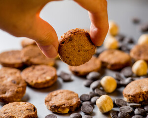 Nuts, cookies and chocolate drops on a gray background. Copy space.