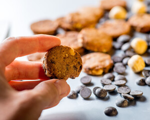 Nuts, cookies and chocolate drops on a gray background. Copy space.