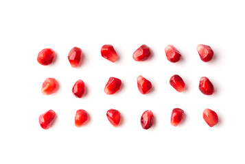 Fototapeta na wymiar Pomegranate seeds are neatly arranged on a white background top view.