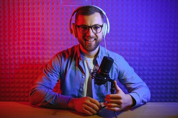 A video blogger records content in his studio. The backstage photo was taken from behind one of the...