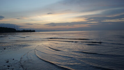 Panoramic beach landscape. Empty tropical beach and seascape. Orange and golden sunset sky, soft sand, calmness, tranquil relaxing sunlight