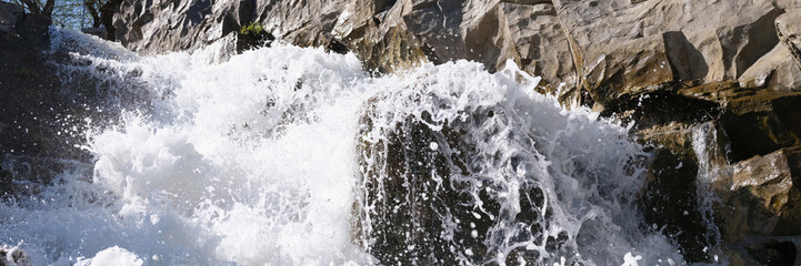 River flowing through rocks and stones closeup