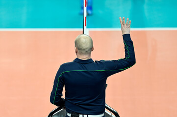 The referee gives a sign with his hand during a volleyball match