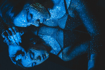 Fashion model woman in neon light, portrait of a beautiful model with fluorescent makeup, artistic design. Cosplay for the movie Avatar. The girl is an avatar.