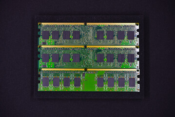 Green RAM strips on black foam. Computer chips close-up. Microchips and memory chips.