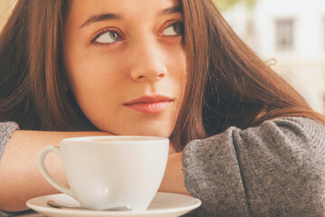 Coffee. Portrait of beautiful woman drinking coffee outdoors in the cafe. Beauty model woman with the cup of beverage.