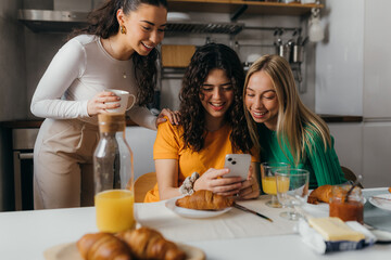 Beautiful Caucasian friends have breakfast together