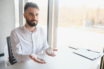 Real estate agent with house model and keys