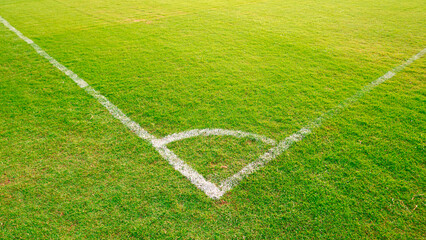 White Corner line on green lawn of soccer (football) field