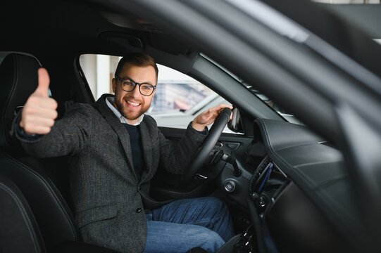 Happy customer just bought a car at car dealership.