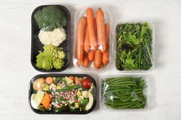 Plastic packages with vegetables - 573658813