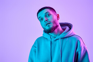 handsome bearded man in sweatshirt on blue background.