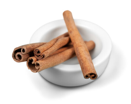 Cinnamon Sticks In White Bowl Isolated On White Background