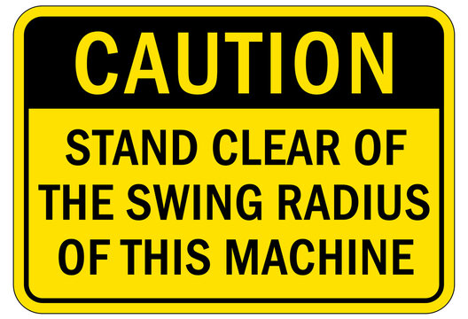 Overhead crane hazard sign and labels stand clear of the swing radius of this machine