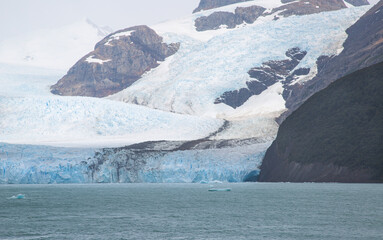 Glacier on the mountain in Patagonia with a lot of ice and green lake