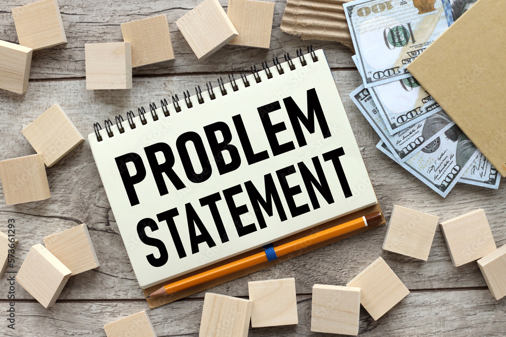 Poster wooden cubes are scattered near the notepad with text. problem statement