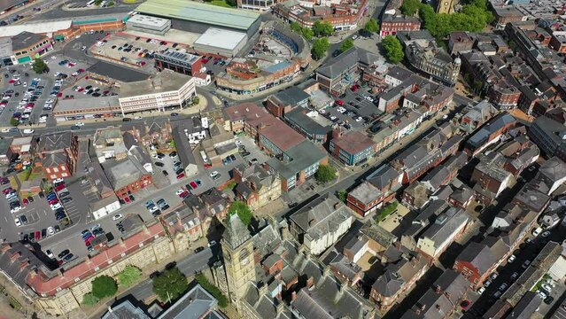 Aerial drone footage of the town of Wakefield and the city centre showing the Main Street in the city with traffic, on a bright sunny summers day showing a typical British town centre