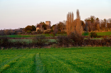 Church in the English countryside with field and trees. Late afternoon just before sunset. St...
