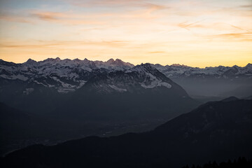 Fototapeta na wymiar Orange sunset on alpine mountains 