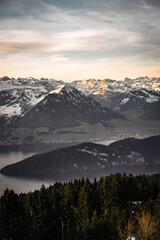 Fototapeta na wymiar Orange sunset on alpine mountains and lake