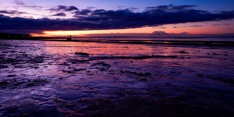 Fototapeta na wymiar Icey beach and early morning light, Seamill, West Kilbride, North Ayrshire, Scotland, UK