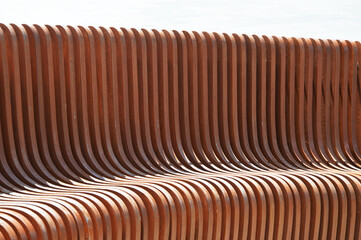 Brown wooden vertical slats. Building facade element. Beautiful abstract background.