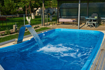 Swimming pool near the terrace in the courtyard of the house.