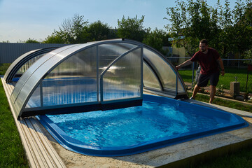 Outdoor swimming pool with sliding cover.