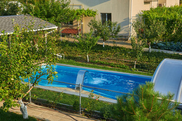 Swimming pool near the terrace in the courtyard of the house.