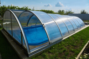 Outdoor swimming pool with sliding cover.