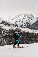 view of male skier walking against winter mountain landscape