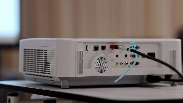 Screen projector. the projector is showing video. digital video projector, rear view. video projector at business conference, seminar or lecture in the office. 