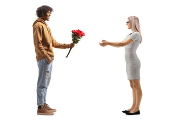 Young african american man giving red roses to a surprised caucasian woman